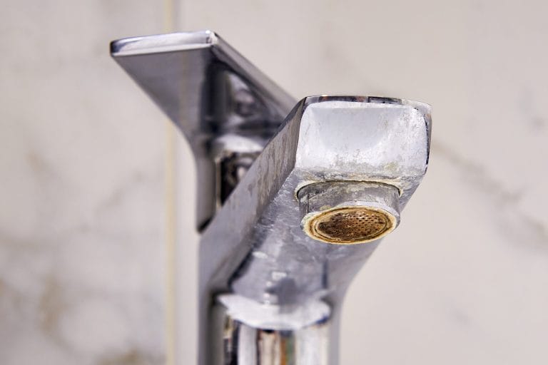 Stock image of a faucet that has been affected by hard water.