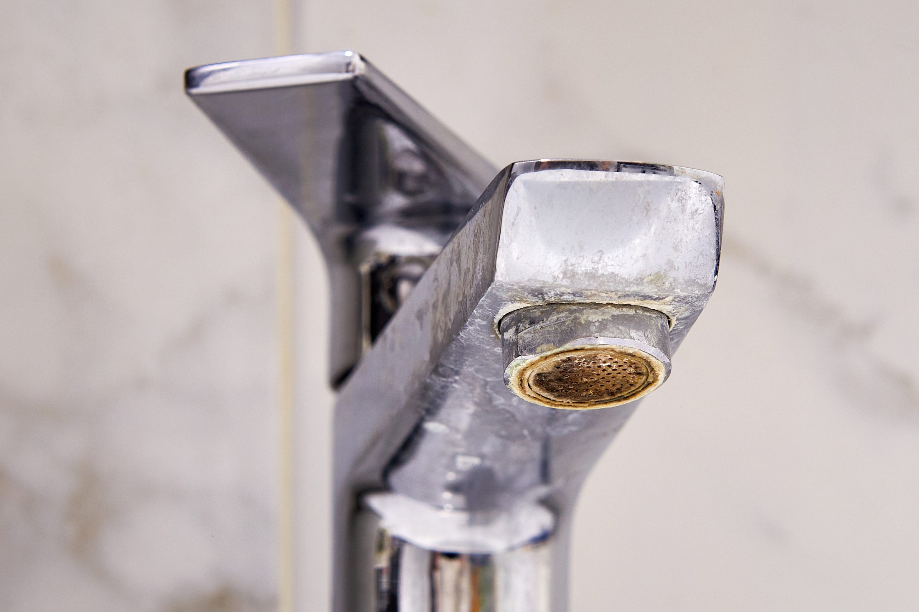 Stock image of a faucet that has been affected by hard water.